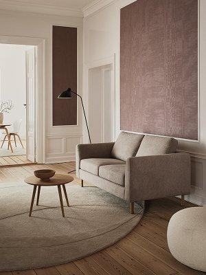 Blue Indivi with wooden legs placed in a minimalist room with white curtains and soft lighting.